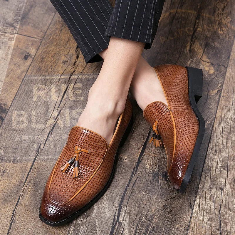 Men's black pointed-toe slip on shoes with a tassel detail on the low-top PU upper.