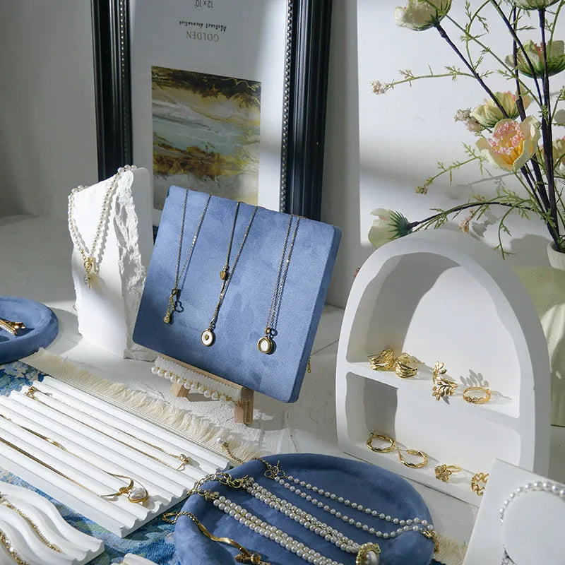 Handmade plaster jewellery display tray with necklaces and bracelets on a countertop