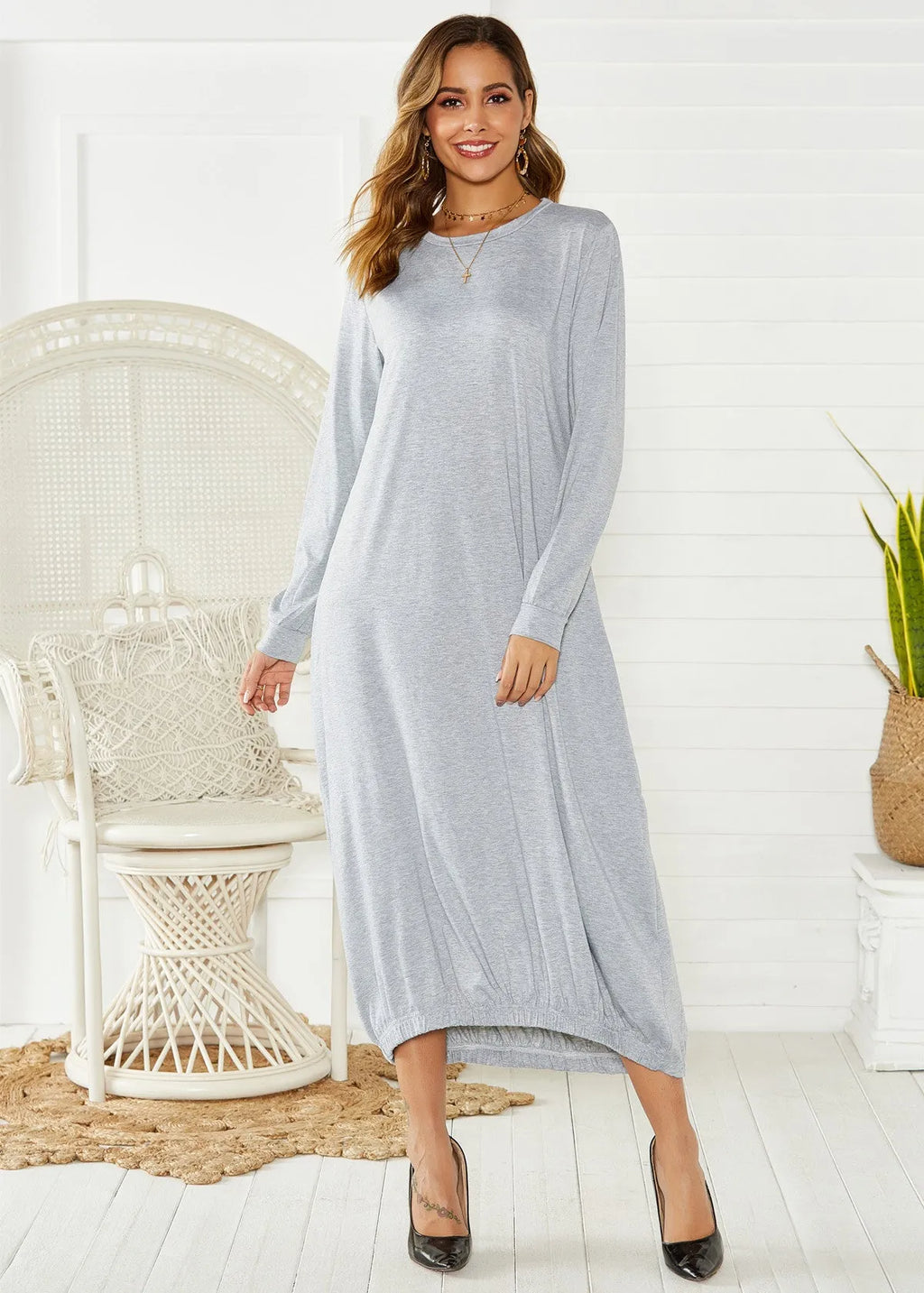 Black knitted lantern dress with loose fit sleeves and lace-up front detail on a mannequin.