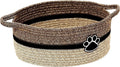 Light beige handmade cotton rope storage basket with a handle on a wooden floor.