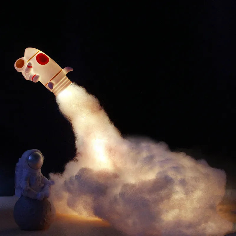 DIY astronaut rocket night light kit components including rocket model, LED string lights, straws, and chassis for assembly