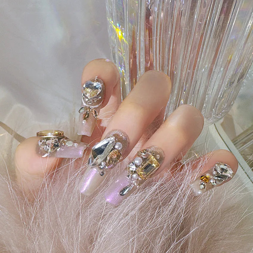 False nail patches with rhinestone detail on card paper packaging showing S number sizing