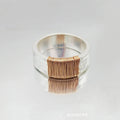 Silver golden geometric copper bracelet with an irregular coil and wide face ring design.