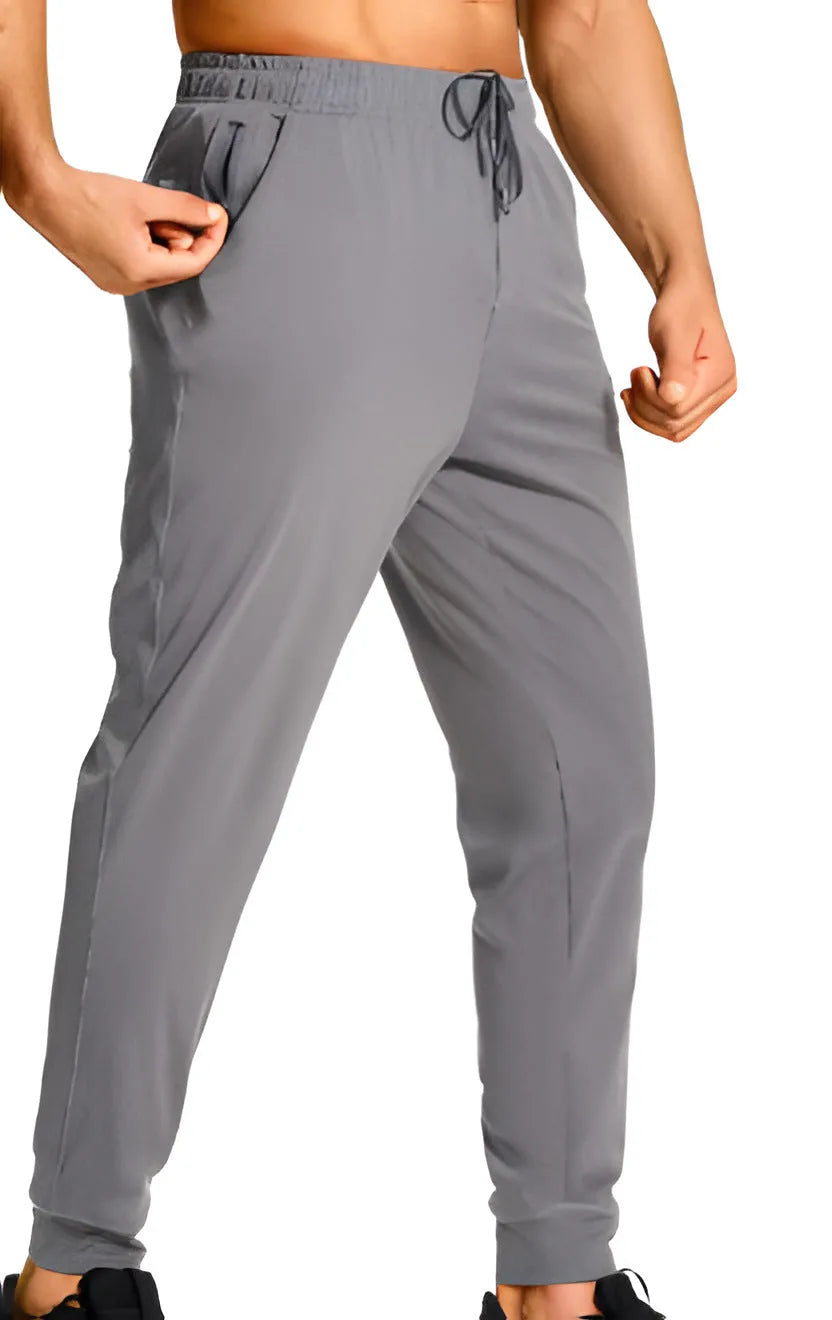 Men's solid colour loose casual trousers in polyester fabric on a hanger.