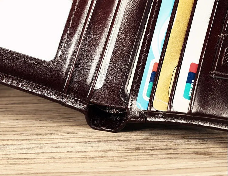 Men's compact leather wallet open showing card slots, change pouch, photo slot, and dark privacy compartment.
