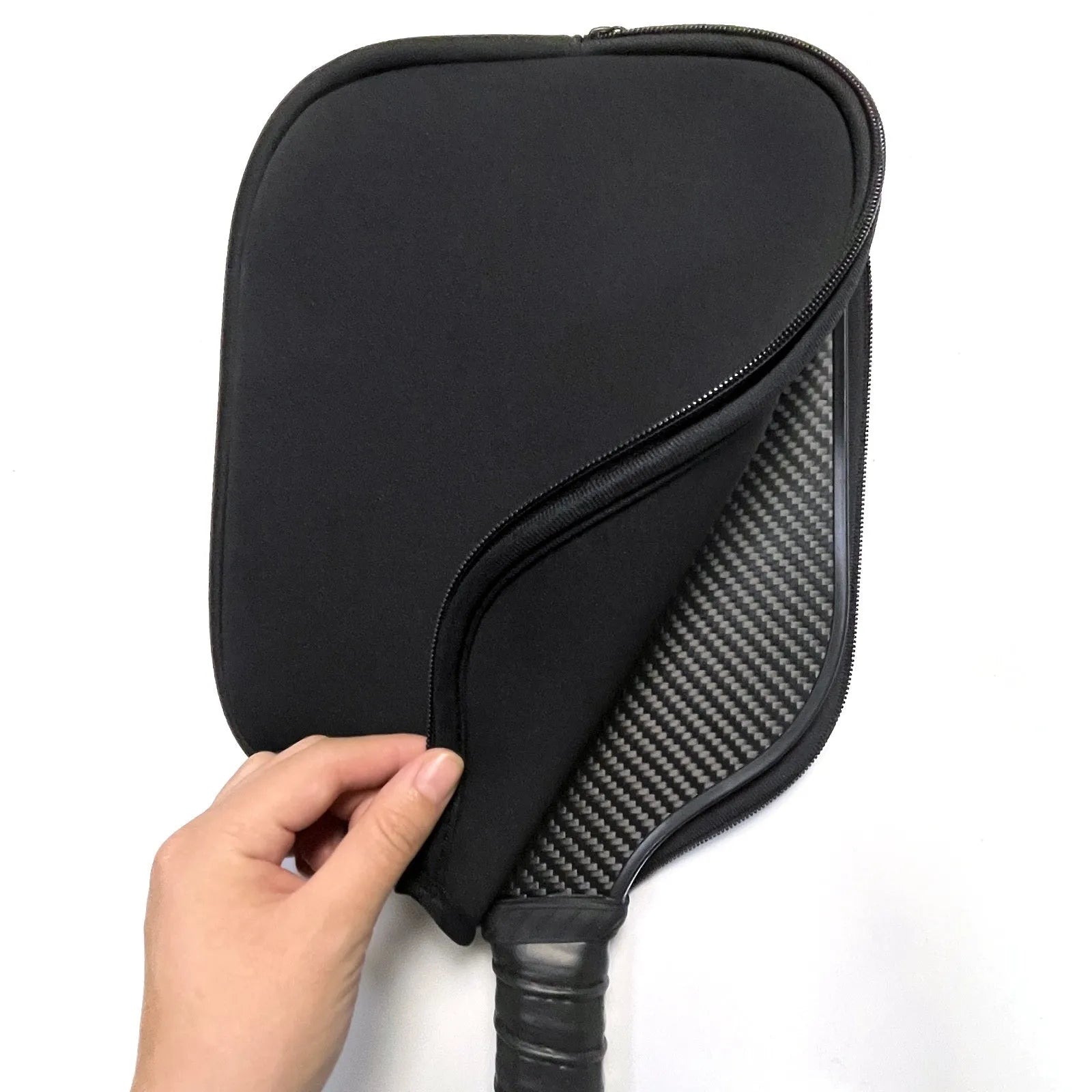 Black neoprene protective sleeve for a table tennis racket on a grey background.