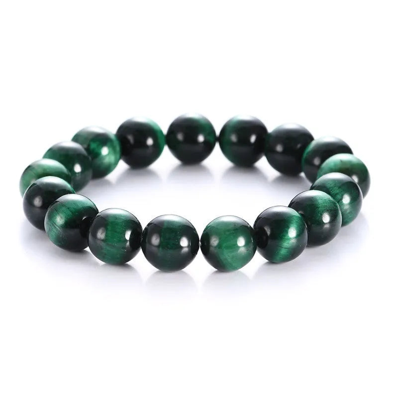 Green Natural Tiger Eye stone bracelet with geometric beads on a wrist.