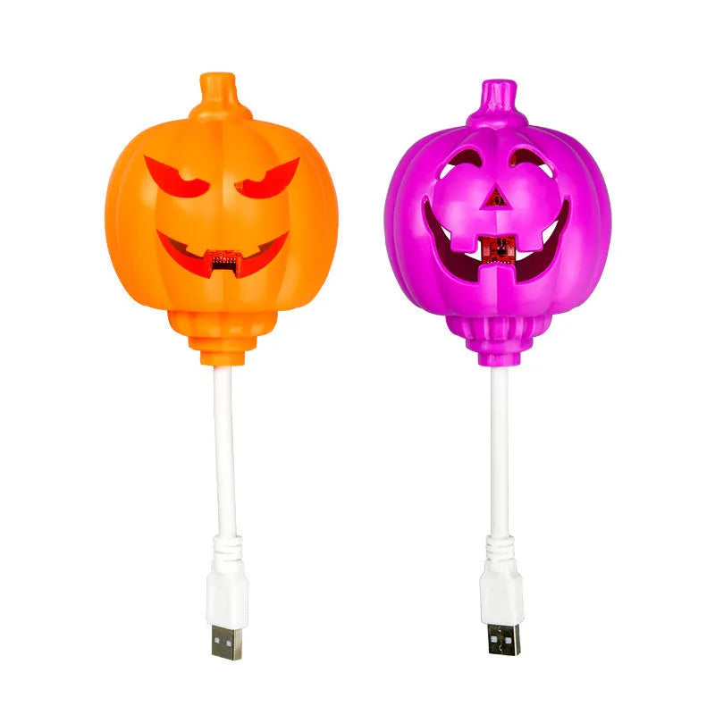 Plastic pumpkin-shaped USB lamp emitting yellow or purple light, 8.3cm wide by 22cm tall