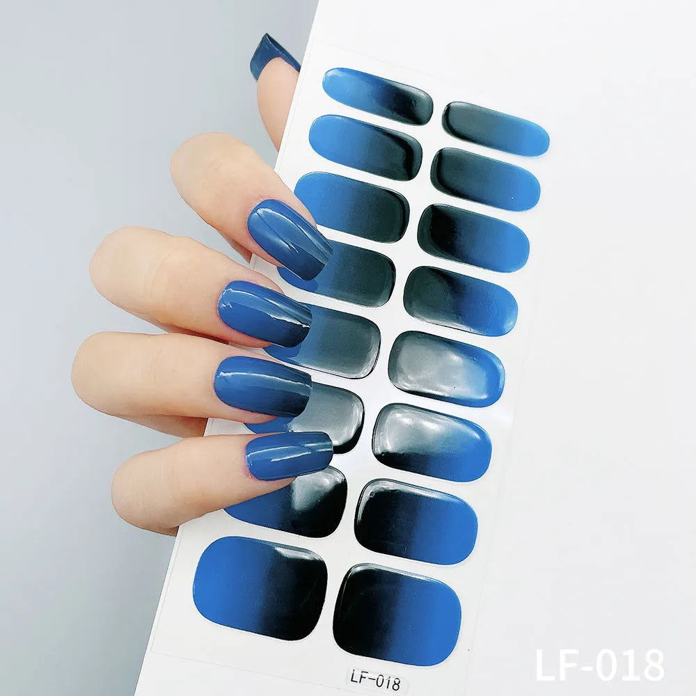 Full sheet of nail art stickers showing sixteen small designs including cross, rose, tulip, and leopard print patterns.