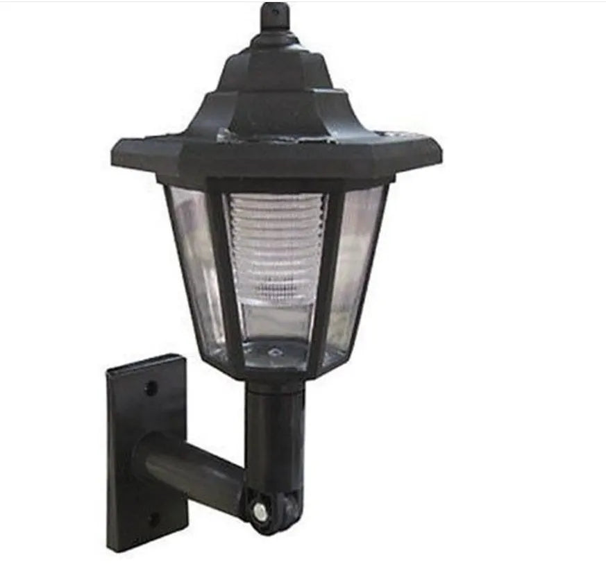 Black hexagonal solar-powered outdoor wall light with a visible solar panel and LED.