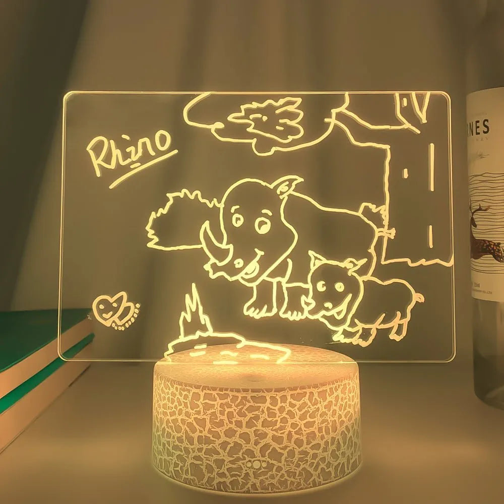Black 3D acrylic LED message board night light with remote control and pen on desk