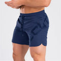 Men's black elastic running shorts with a mid-waist and knee-length cut on a plain background.
