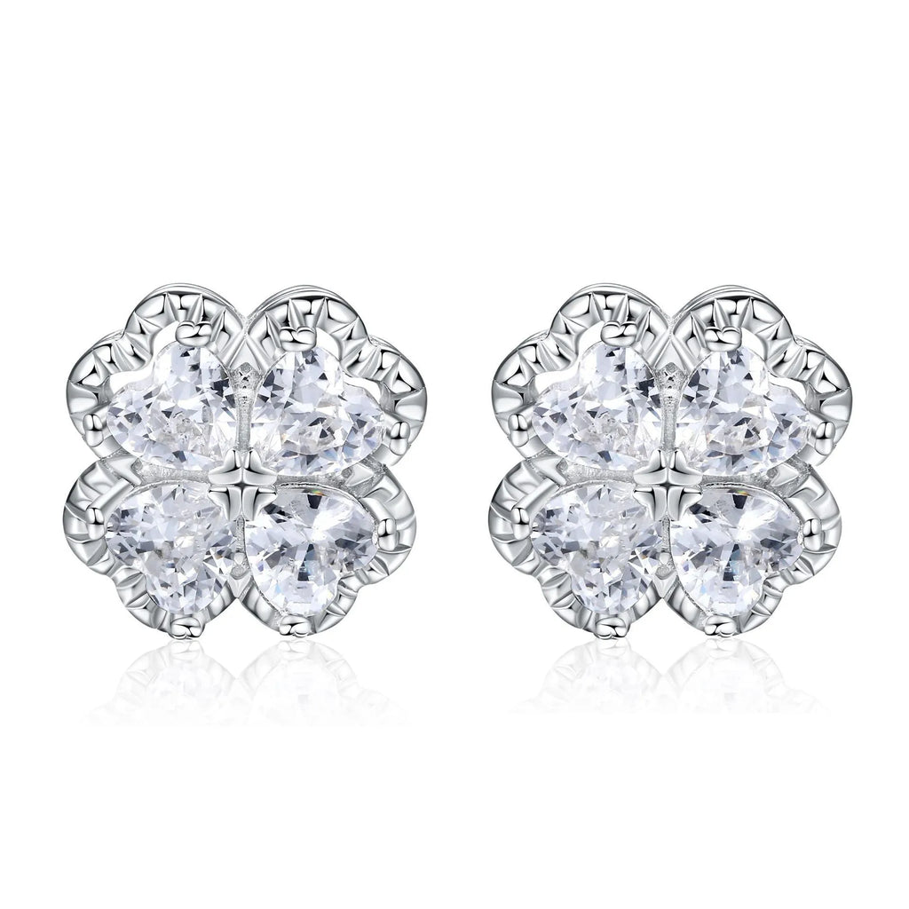 Pair of heart-shaped silver earrings with a four-leaf clover design and zircon stones.