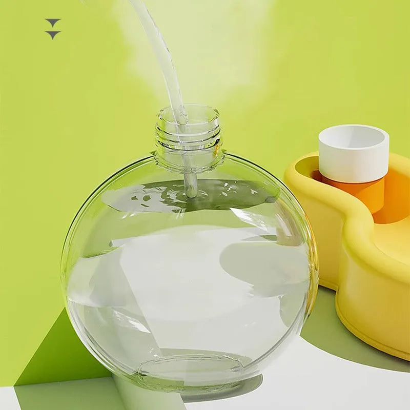 Green portable pet travel cup with pull-out water bowl, shown next to a dog.