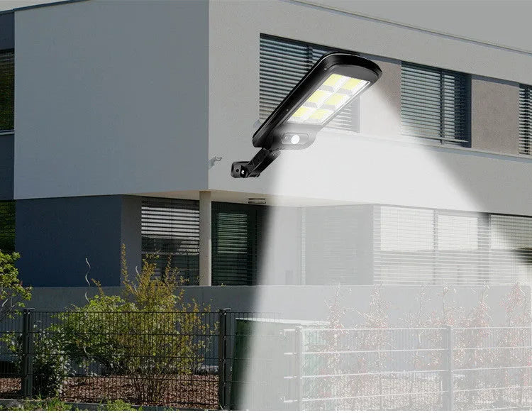 Black solar-powered outdoor security light with motion sensor for garden and driveway illumination