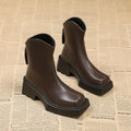 Black platform Martin boots for women with square toe and back zipper on a white background.