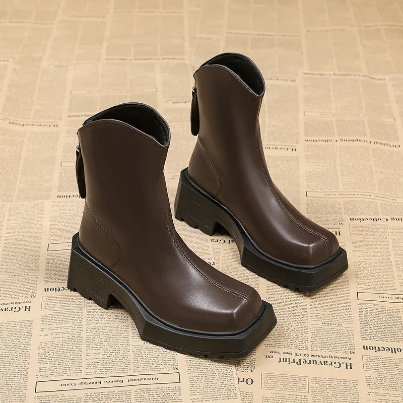 Black platform Martin boots for women with square toe and back zipper on a white background.