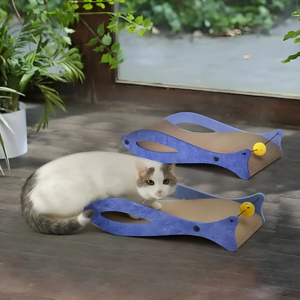 Blue fish-shaped cat scratcher with wavy lounge design and hanging bell ball toy for indoor feline enrichment