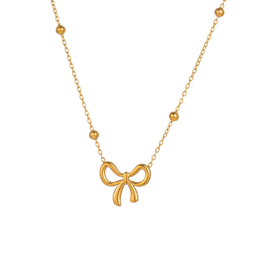 Gold electroplated bow pendant fashion necklace on a cross chain, adjustable 41-50cm.