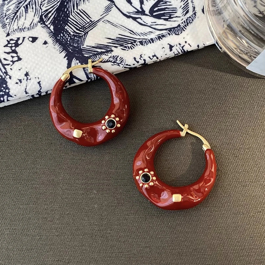 Black and red alloy ear studs with rhinestone inlays and dripping oil textured surface