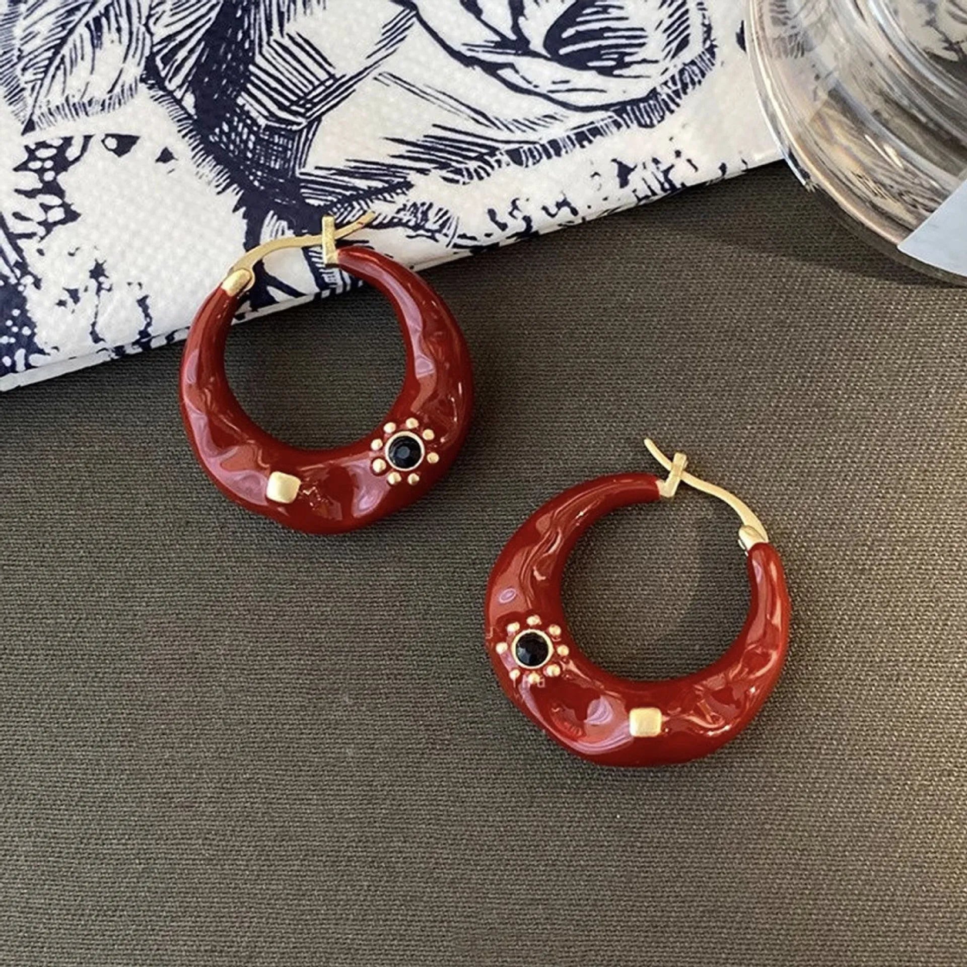 Black and red alloy ear studs with rhinestone inlays and dripping oil textured surface