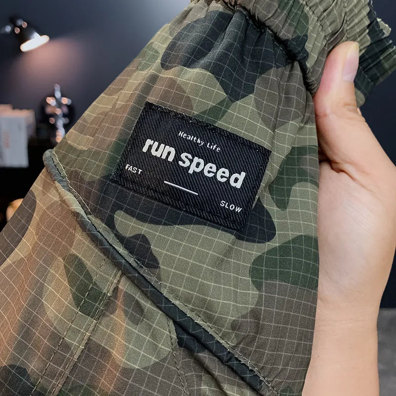 Man wearing loose-fit camouflage cargo shorts with multiple pockets, made from a cotton blend fabric.