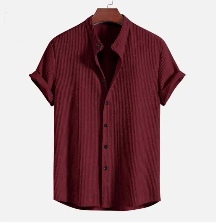 Man wearing a loose-fit short sleeve casual shirt in a solid colour, available in multiple sizes.
