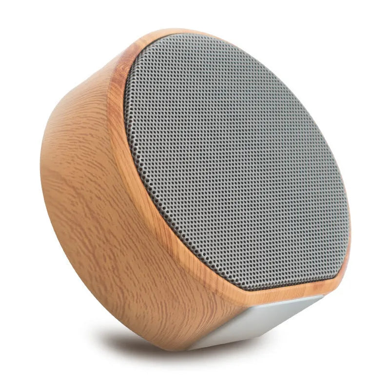 White wood grain Bluetooth speaker on a desk