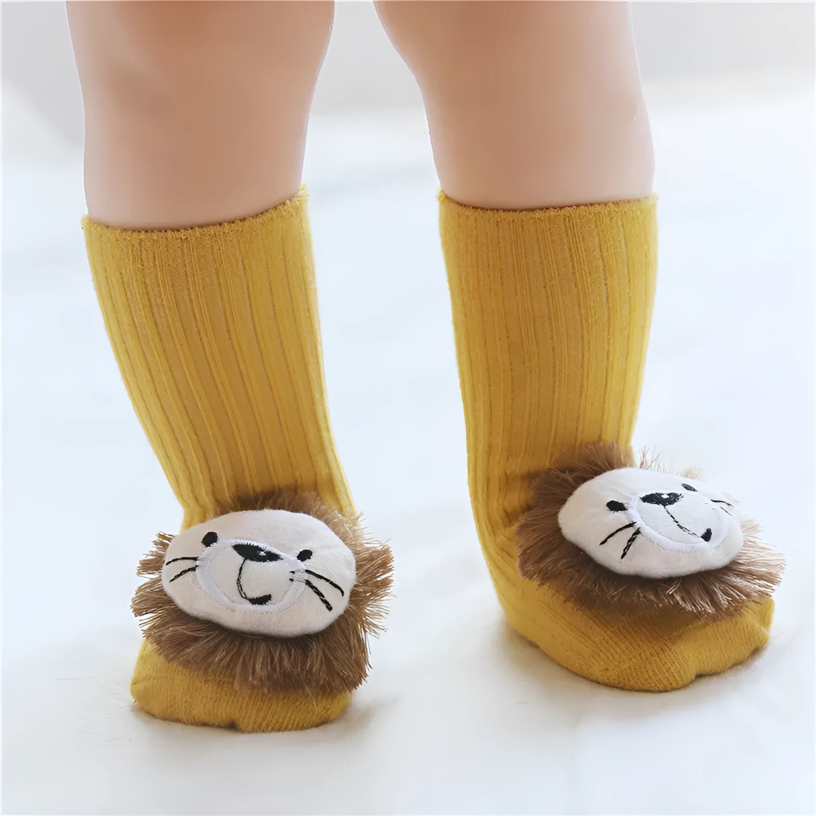 Cotton baby socks in multiple colours and prints including panda, lion, bows, and stars on a white background.