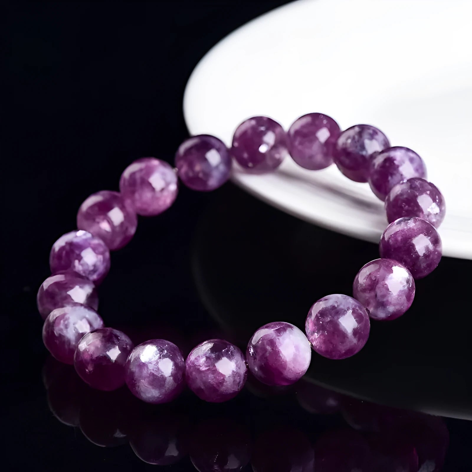 Purple geometric crystal bracelet with polished beads, shown in different size options.