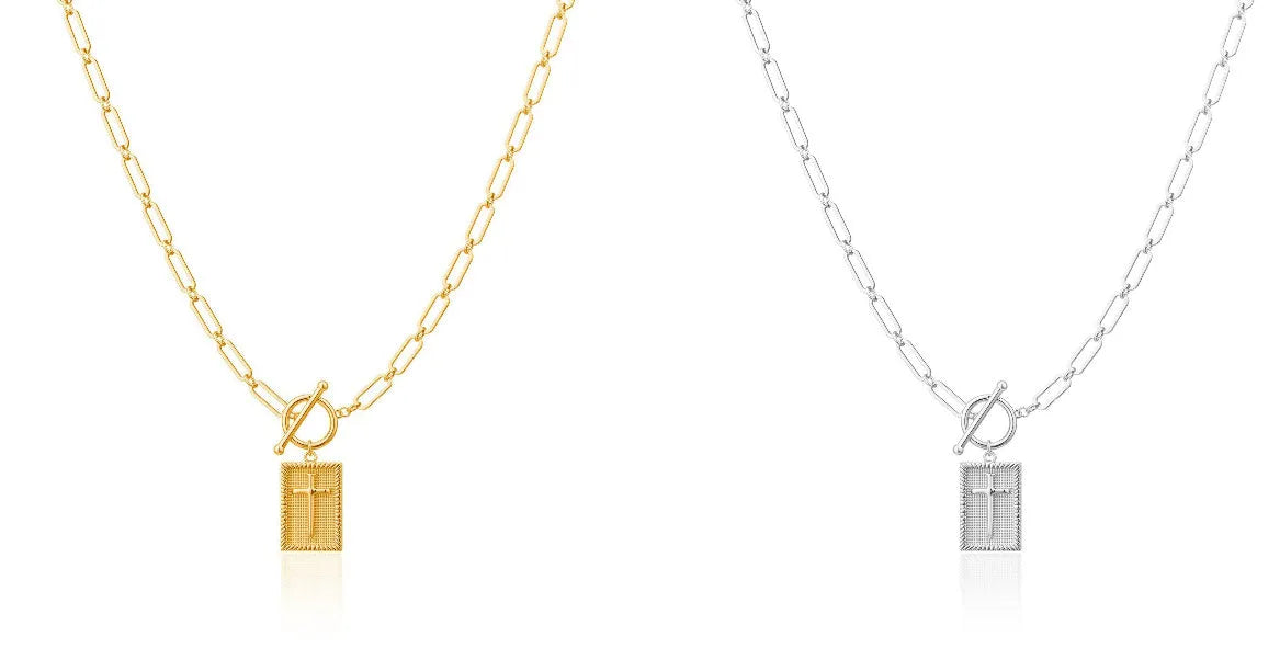 Gold electroplated stainless steel clip chain necklace with cross and square geometric pendant on white background