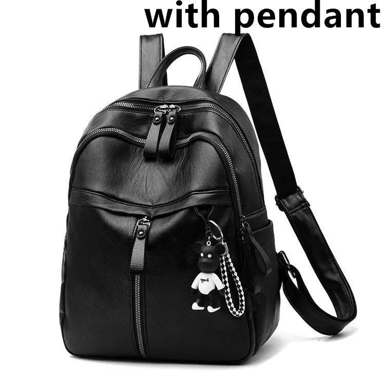 Black soft-surface leather backpack with 24-litre capacity showing ID pocket and luggage strap attachments