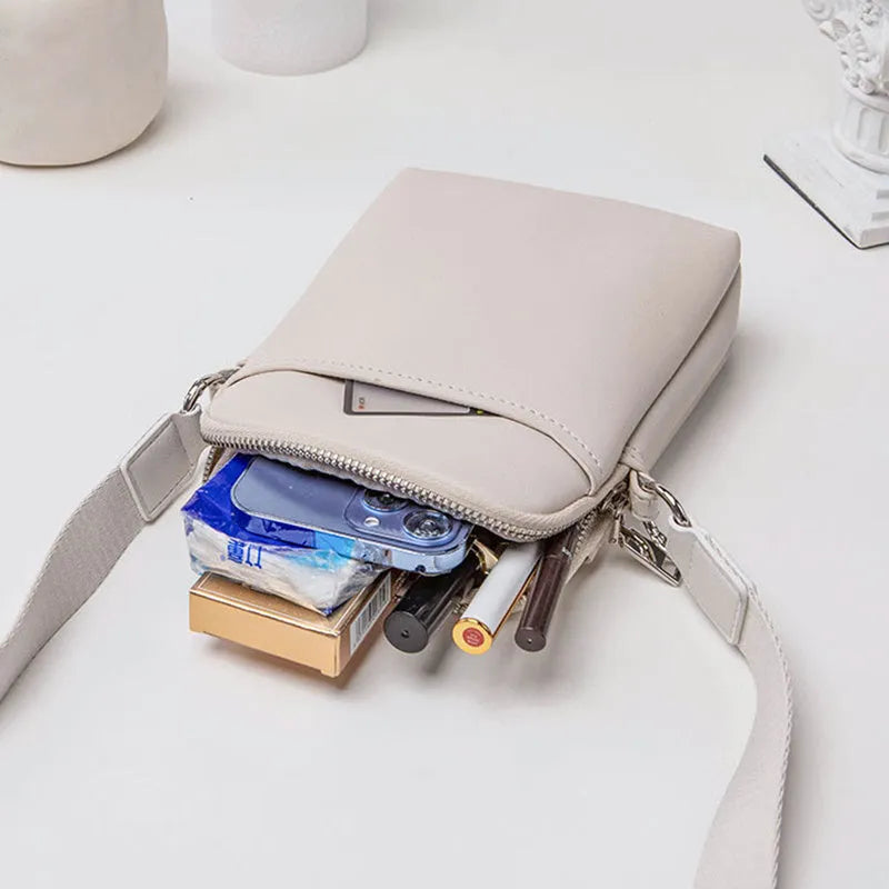 Small solid colour PU leather crossbody bag for women in black, shown with shoulder strap.