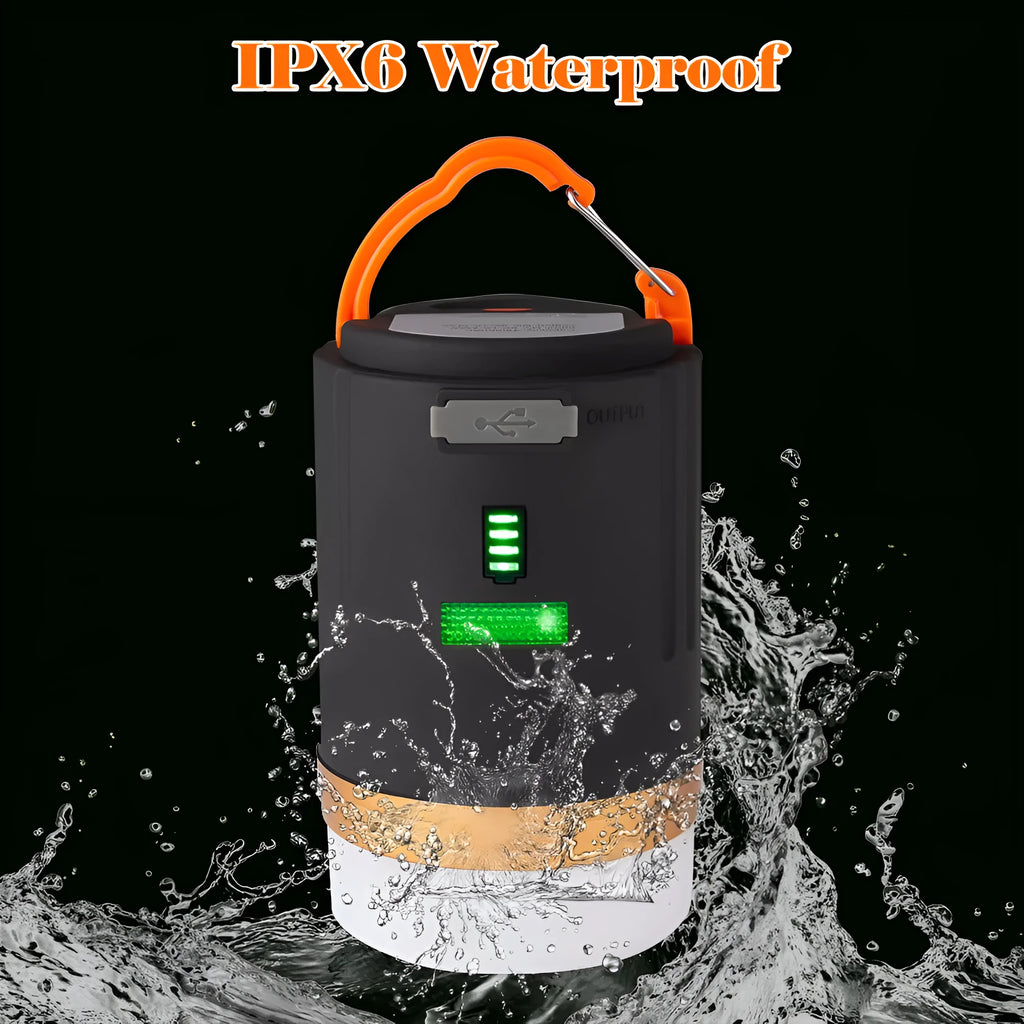 Black rechargeable LED camping light with hanging hook and remote control on a table
