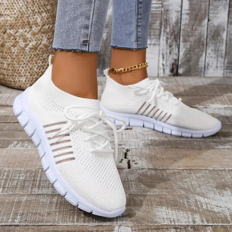 Women's breathable mesh flat shoes in various colours with front tie and round toe.