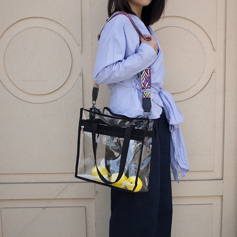 Women's transparent PVC messenger bag showing three-dimensional pocket and crossbody shoulder straps