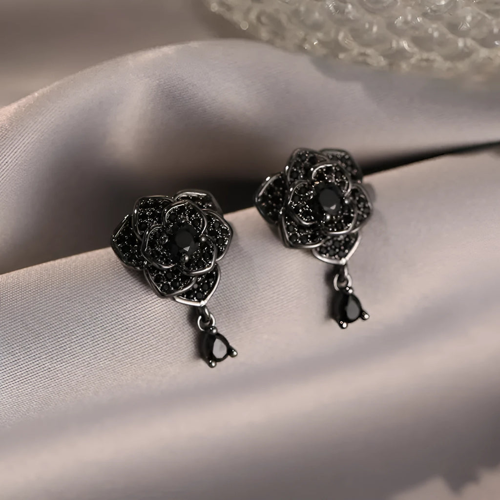 Pair of black rose zircon floral stud earrings with an 18K gold electroplated finish on copper.