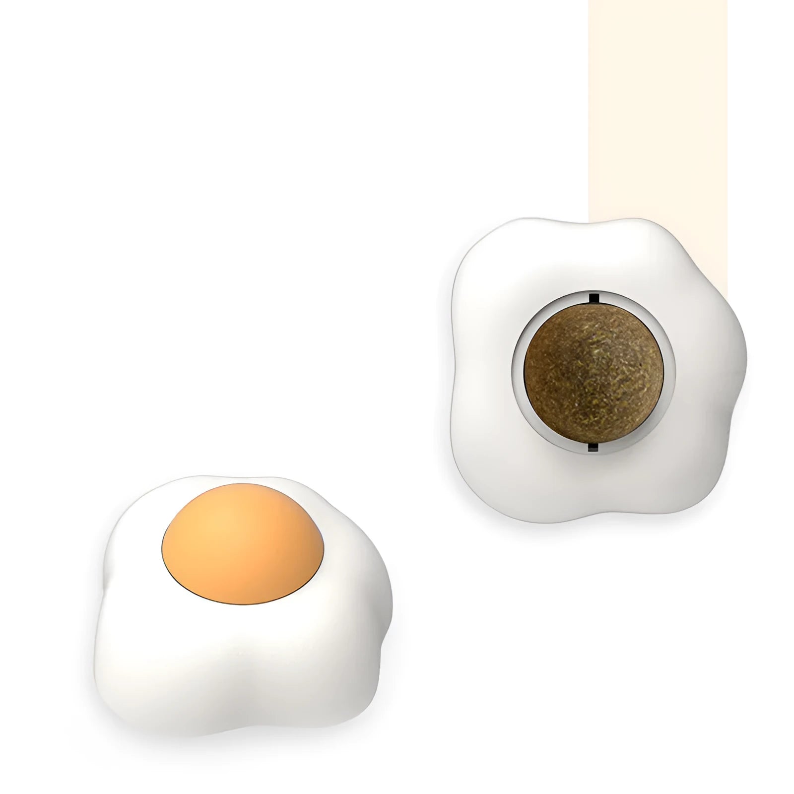 Soft plush catnip ball toy in egg shapes stuck to a wall for interactive cat play.