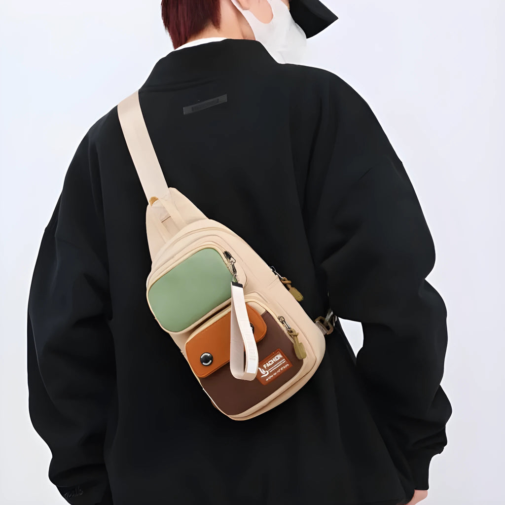 Black nylon crossbody bag with contrast colour accents and a polyester lining.