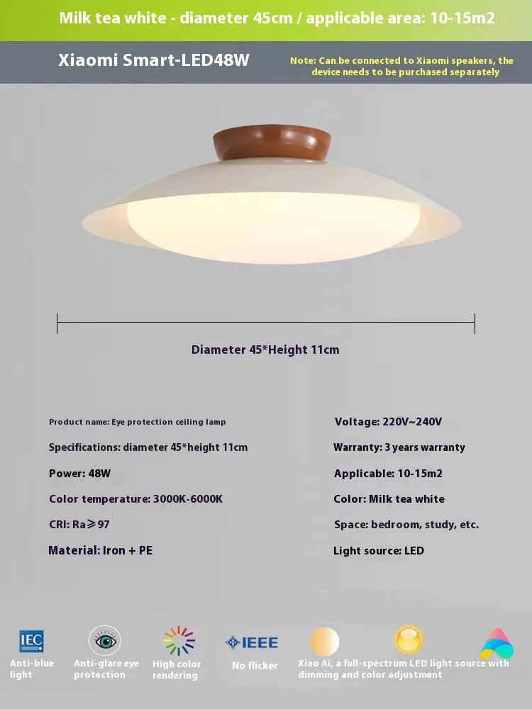 Modern minimalist cream style flying saucer ceiling lamp in mint green on a white ceiling.