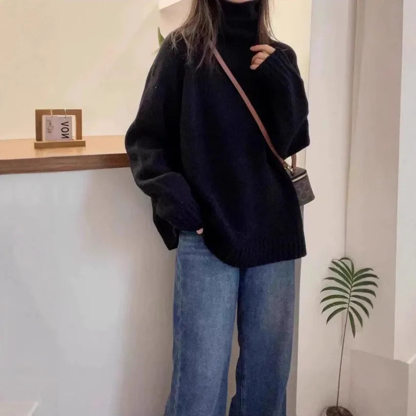 Women's thick loose turtleneck sweater in black with curling pile collar and 3D pattern
