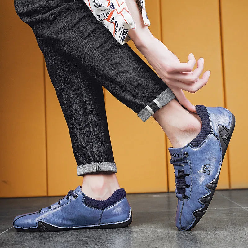Men's solid colour lace-up casual sneakers with car stitching, blue upper, side view