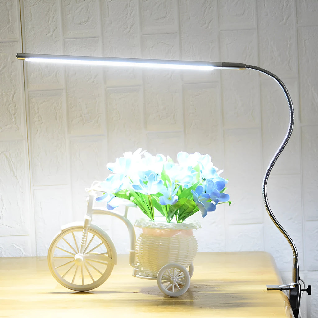 Silver aluminium alloy LED clip-on table lamp with long adjustable arm for nail art lighting.