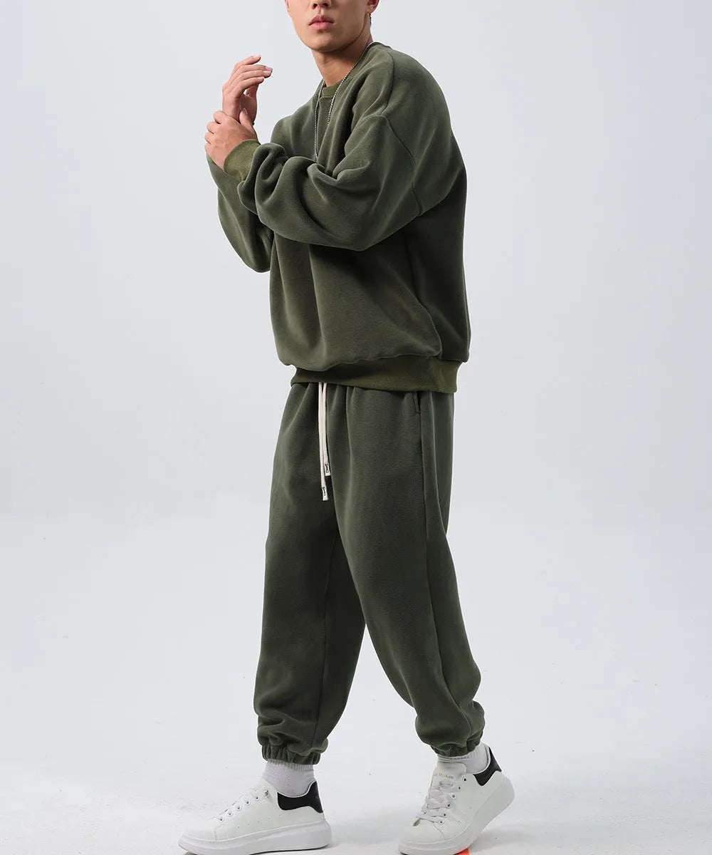 Men's polar fleece tracksuit set showing crew neck top with padded trousers in winter sportswear style