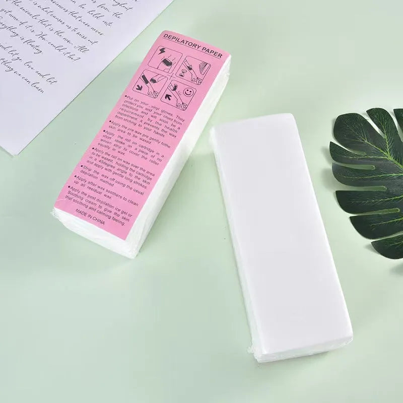 Pack of soft non-woven fabric hair removal wax paper strips on a pink background
