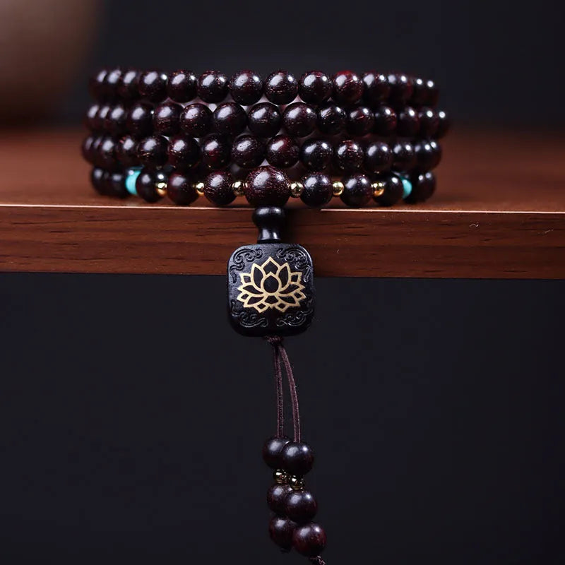 Zambia rosewood DIY bead bracelet with flat lotus pendant ornament on wooden surface