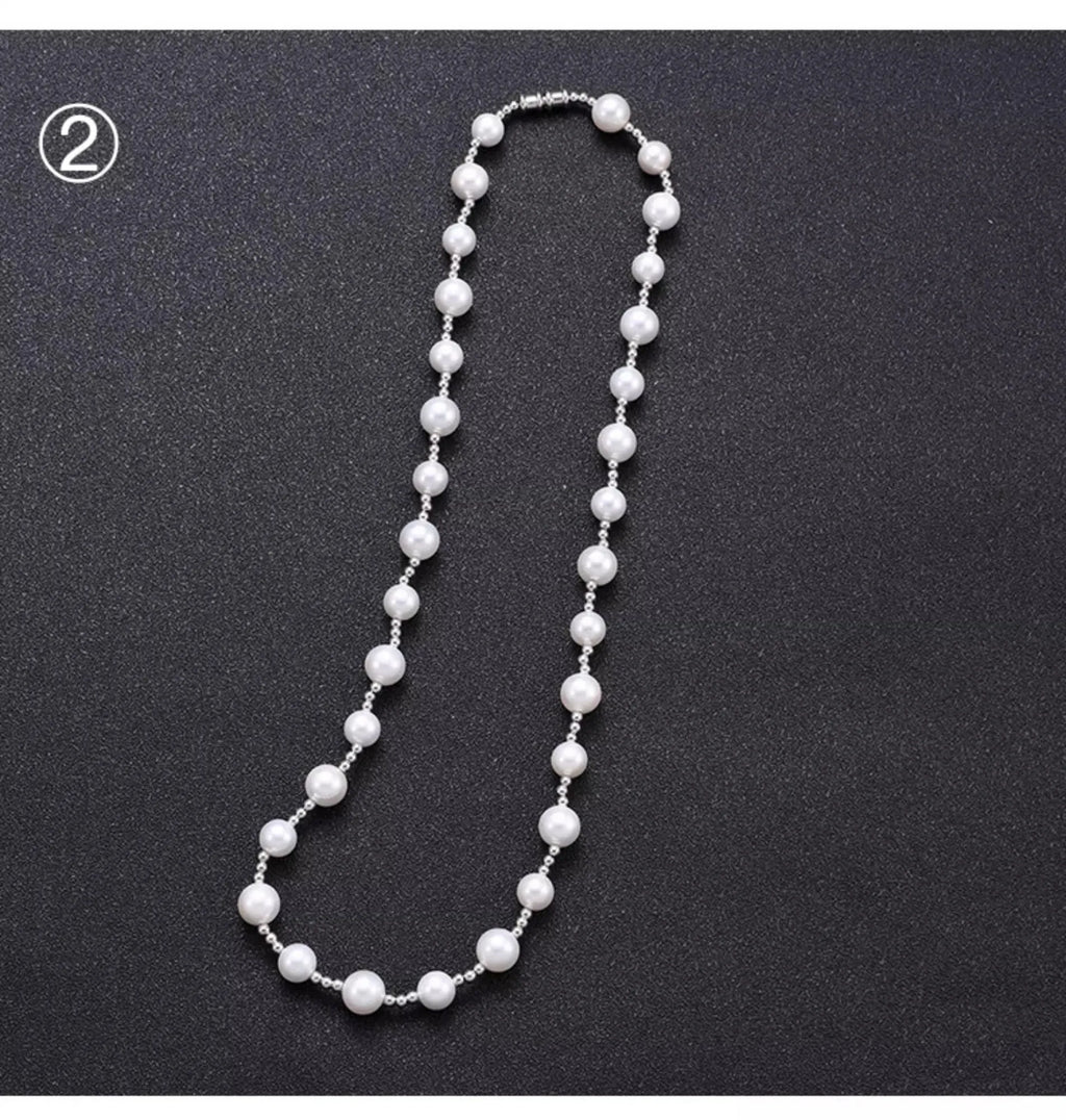 White freshwater pearl necklace with round bead chain and sterling silver platinum beads on a neutral background
