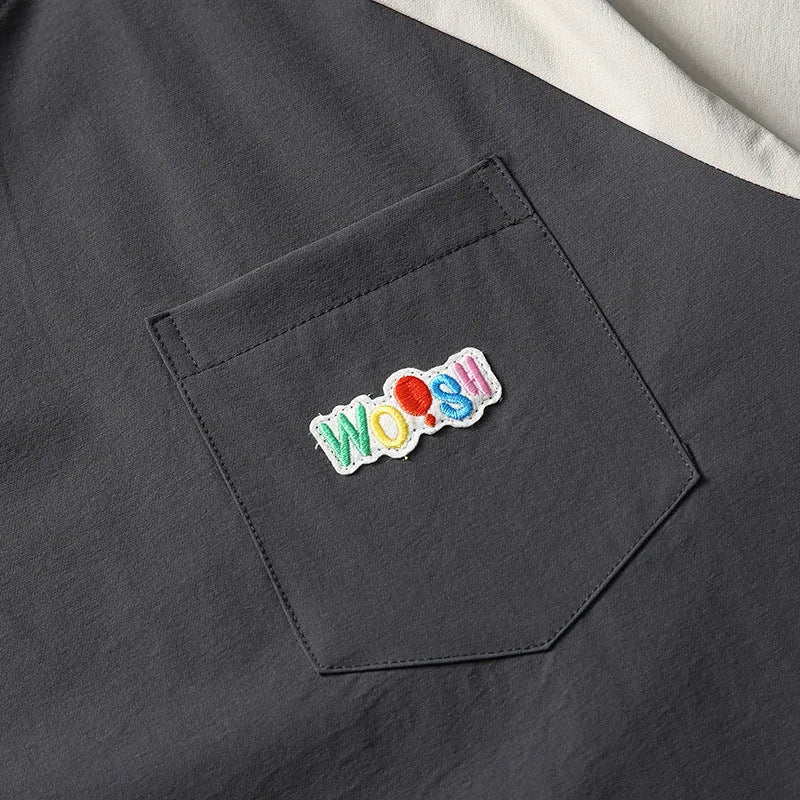 Dark grey men's loose-fit T-shirt with contrast colour raglan sleeves on a hanger.