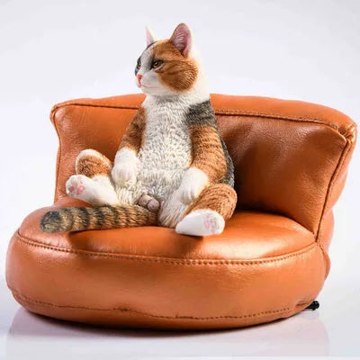 Lazy cat model ornament with sofa on car dashboard, 7.5cm high resin decoration.