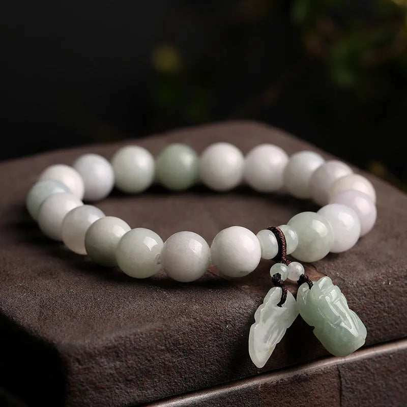 Natural jade Buddhist hanging bracelet showing geometric shape and symbolic charms